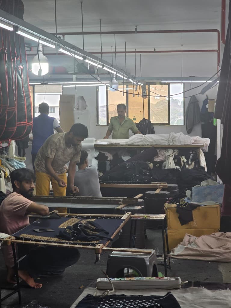 Wide workshop floor showing artisans collaborating at VastraVibe